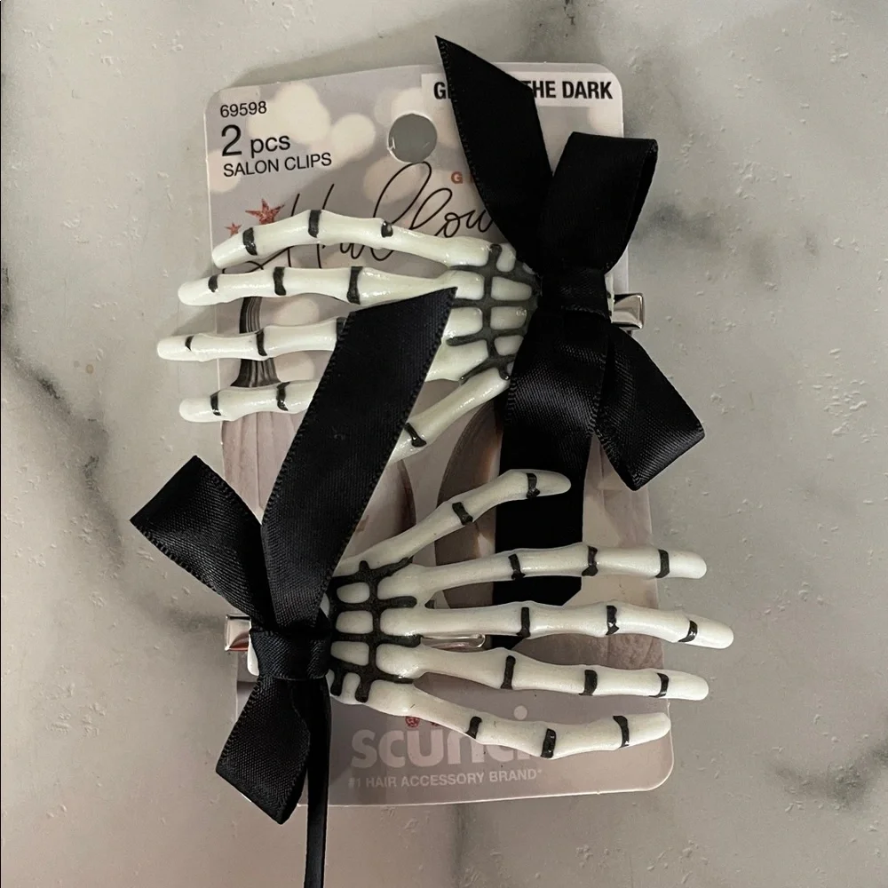 These are Scunci Glamoween Glow-in-the-Dark Skeleton Hand Hair Clips Halloween